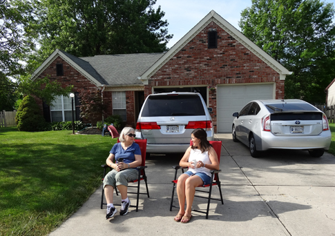 Becky and Tasha out front watching the kids play and ride bikes