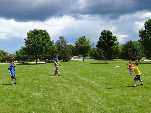 The boys playing Frisbee 